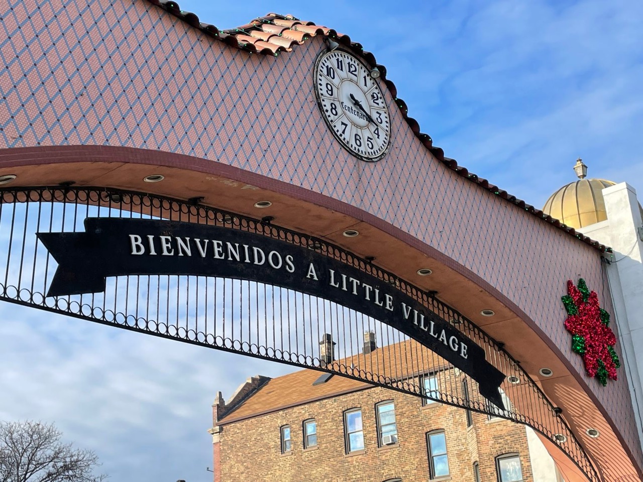 The Bienvenidos a Little Village arch with clock on 26th Street